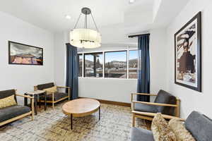 Living area with recessed lighting, a mountain view, and wood finished floors