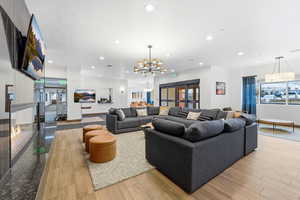 Living area featuring suspended lighting and light wood finished floors