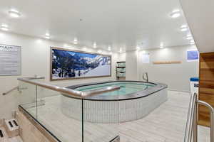 Misc room with a jacuzzi and wood finish floors