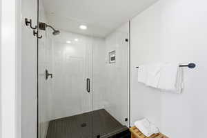 Bathroom with a shower stall and recessed lighting