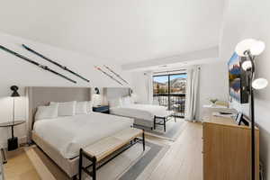 Bedroom featuring light wood finished floors and access to outside