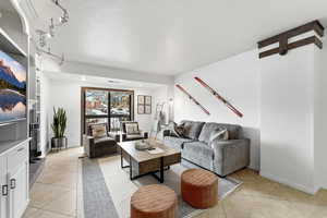 Living area with a textured ceiling and light tile patterned floors