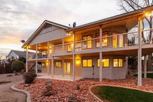 Rear view of house with covered porch and deck