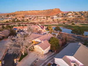 Aerial perspective of suburban area featuring ponds and mountain view and a golf course