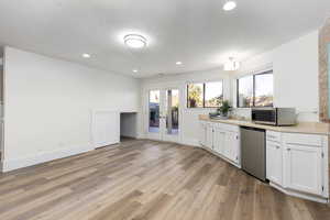 Kitchenette space and a storage cubby beneath the stairs