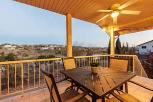 Deck with outdoor dining space and ceiling fan outside the interior dining room