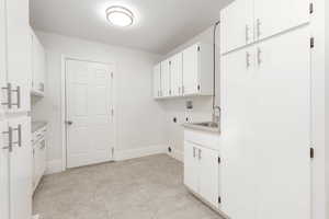 Laundry area with cabinet space, electric dryer hookup, and washer hookup