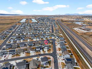 Aerial view of property's location with nearby suburban area and mountains