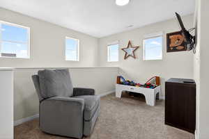 Living area with carpet and baseboards