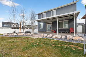 Rear view of house featuring a patio, a fenced backyard, a storage shed, a residential view, and stucco siding