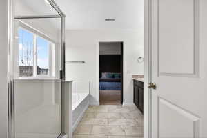 Full bath with a garden tub, vanity, a shower stall, connected bathroom, and light tile patterned floors