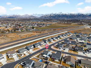Aerial overview of property's location featuring nearby suburban area and a mountainous background