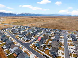 Aerial perspective of suburban area featuring a mountain backdrop