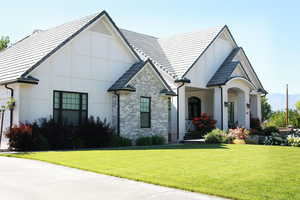 View of front of house with a front yard and brick siding