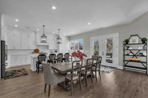 Dining area with light wood-style flooring, recessed lighting, and french doors