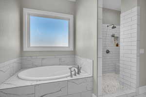 Bathroom with a garden tub and tiled shower