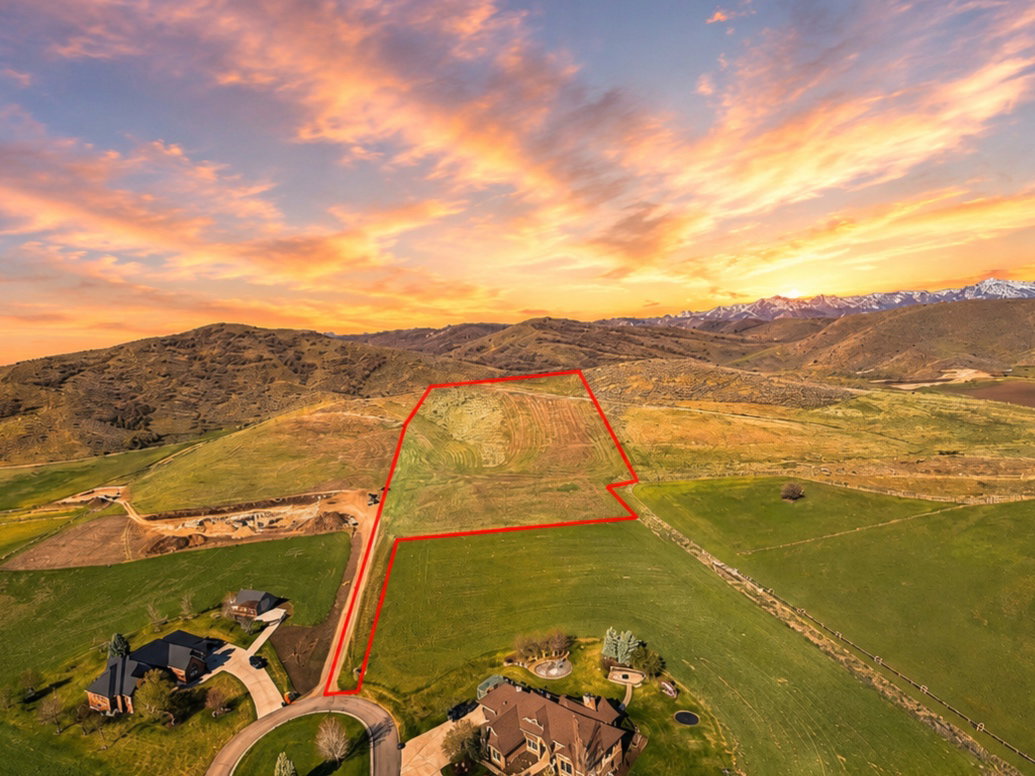 Expansive undeveloped parcel outlined in red, featuring a gently sloped terrain