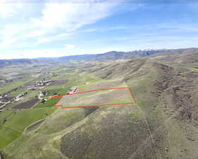 Aerial view of property and surrounding area featuring property boundaries highlighted and mountains
