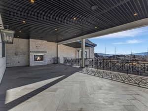 Kitchen walkout patio / terrace featuring a fireplace and a mountain view