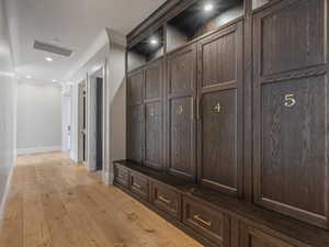 Mudroom from the garage with light wood-style flooring and recessed lighting