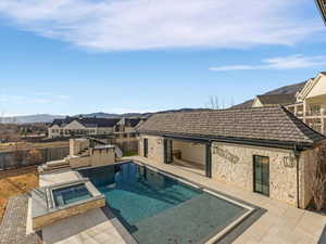Primary bedroom private patio view of pool / spa featuring a patio, a fenced backyard, and a residential view