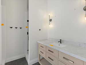 Pool Casita double shower bathroom with vanity, dark tile patterned floors, and a shower