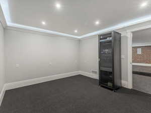 Media controls for theatre and storage featuring dark colored carpet and recessed lighting