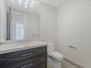 Half bath with vanity and a textured ceiling
