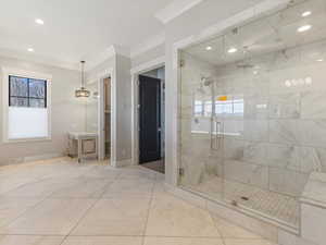 Primary bathroom with a stall shower, ornamental molding, and recessed lighting