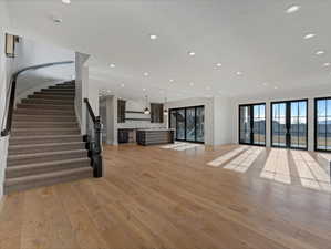 Unfurnished living room featuring light wood finished floors, french doors, and recessed lighting