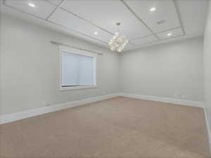 Bedroom featuring light carpet and a chandelier