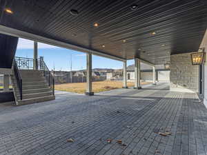 Lower-level walkout from kitchen to patio / terrace featuring a residential view and stairway