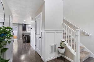 Main-level entry featuring LVP flooring, recessed lighting, and custom board and batten interior design details.