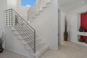 Staircase featuring tile patterned flooring and recessed lighting
