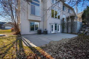 Back of house with a patio and stucco siding