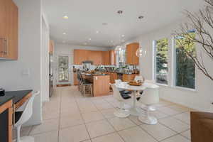 Dining space with light tile patterned floors, recessed lighting, and healthy amount of natural light