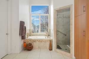 Bathroom with a shower stall, a garden tub, and tile patterned floors