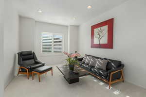 Carpeted living room featuring recessed lighting