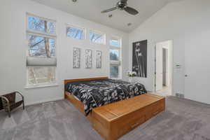 Bedroom featuring vaulted ceiling, carpet, and a ceiling fan