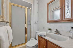 3/4 Primary bathroom featuring a shower stall and vanity