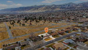 Aerial overview of property's location featuring nearby suburban area and mountains