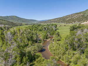 View of mountain background featuring a tree filled landscape and rural landscape