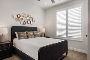 Bedroom with dark colored carpet, recessed lighting, and a ceiling fan