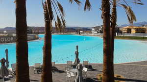 Community pool with a mountain view and a patio