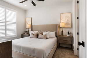 Carpeted bedroom featuring a ceiling fan and recessed lighting