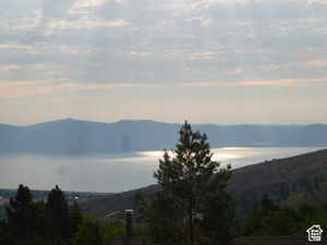View of mountain backdrop featuring a nearby body of water