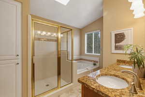 Full bath featuring a shower stall, double vanity, a bath, and lofted ceiling