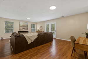 Living area with wood finished floors and baseboards