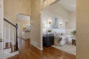 Entrance foyer featuring dark wood-type flooring and vaulted ceiling