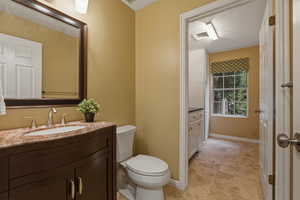 Half bath with vanity, a textured ceiling, and light tile patterned flooring